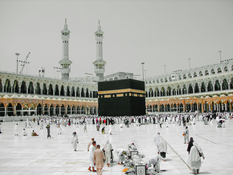 The Kaaba at Masjid al-Haram in Makkah with pilgrims in the courtyard
